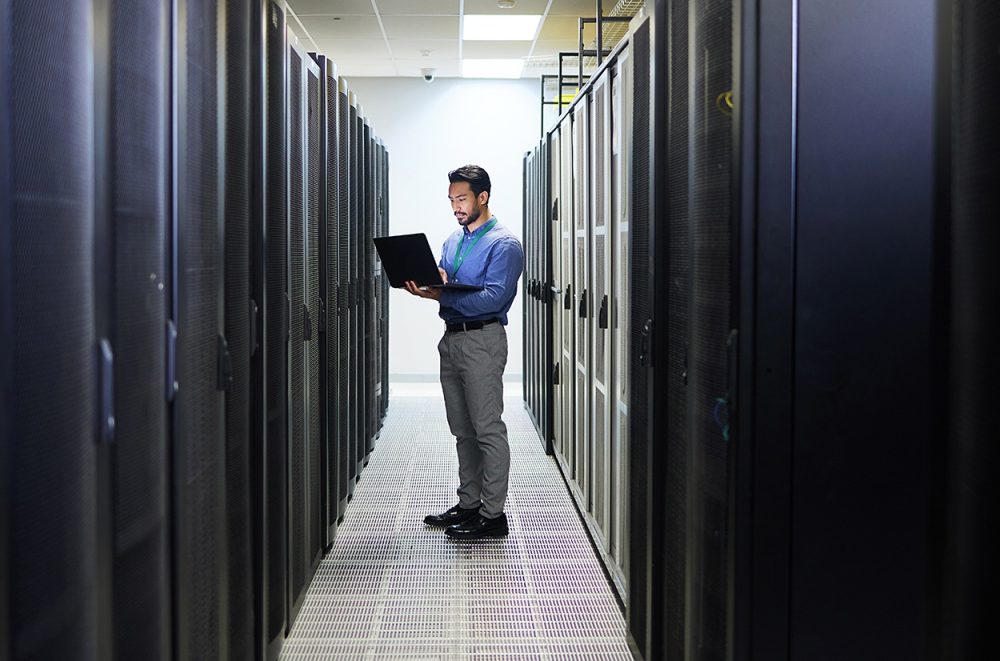 Server room, laptop or man typing for cybersecurity glitch, machine or to search online for servers system. IT support, data center or engineer fixing network for information technology solution